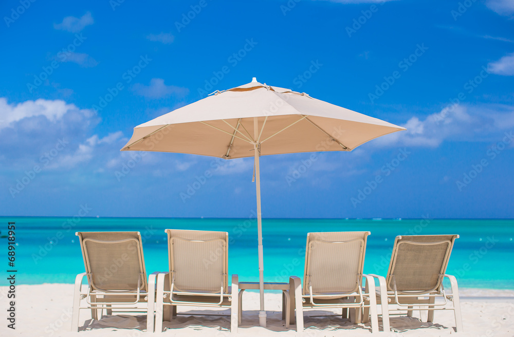 White umbrellas and sunbeds at tropical beach White umbrellas and sunbeds at tropical beach