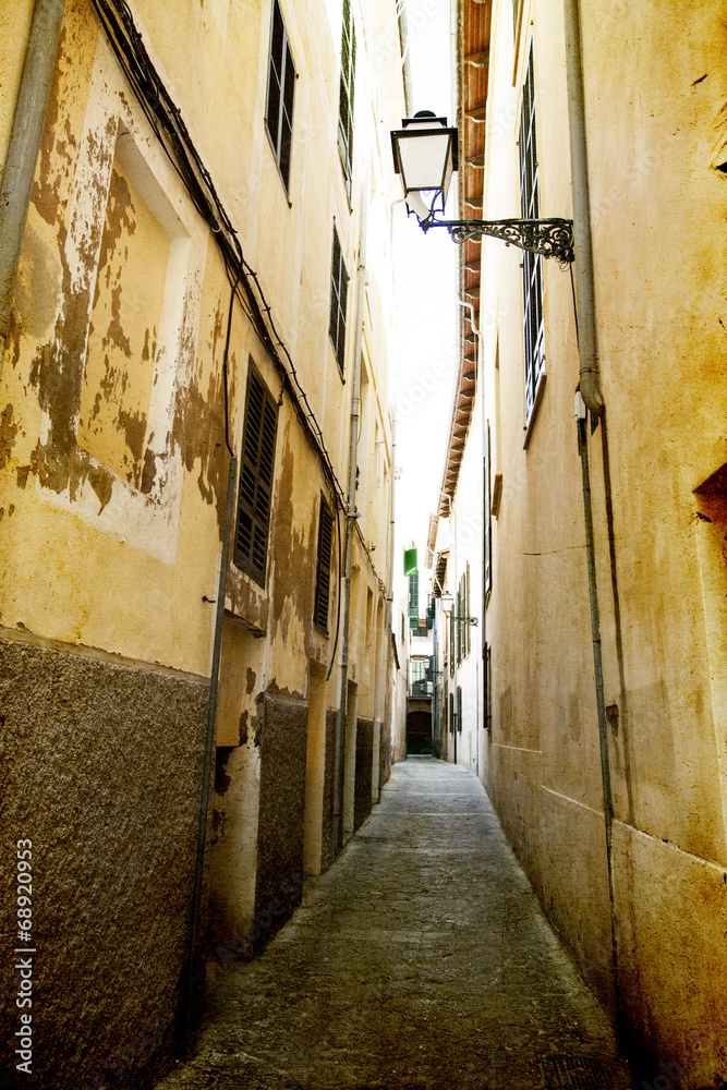 Narrow street in old city of Palma de Mallorca, Spain