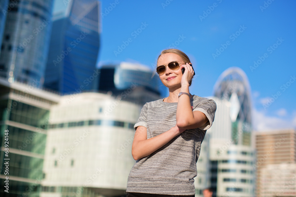 Fototapeta premium Young business woman speaking on the phone