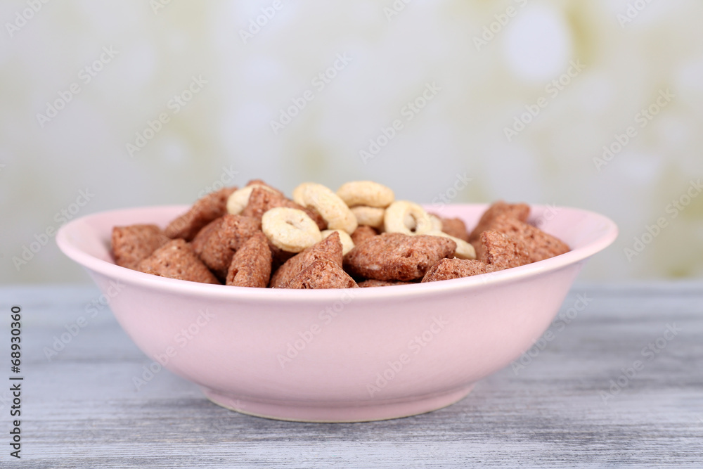 Dry breakfast in pink plate on wooden background Dry breakfast in pink plate on wooden background