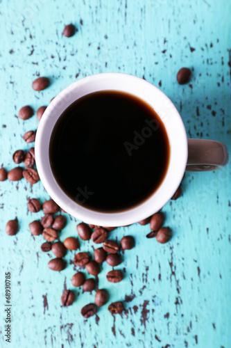 Polka dot mug of coffee beans isolated on white