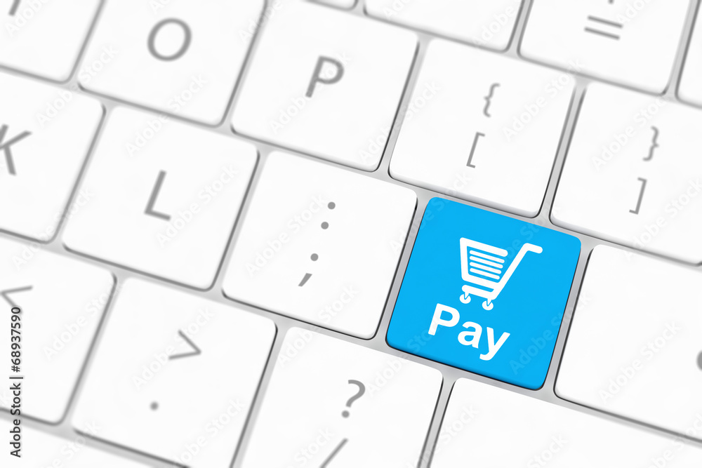 Pay key with shopping cart icon on a white keyboard Pay key with shopping cart icon on a white keyboard