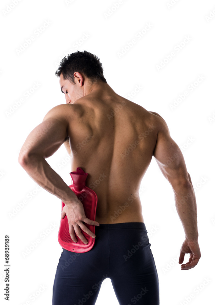 Back of man with hip or kidney pain, holding hot water bottle