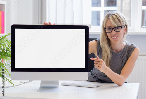 Creative young woman showing blank presentation on screen