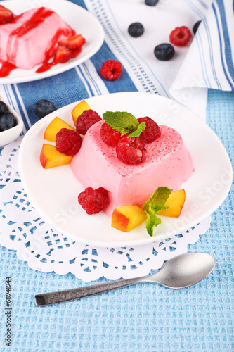 Tableau sur toile Cakes with fruit and berries on plate on lace napkin