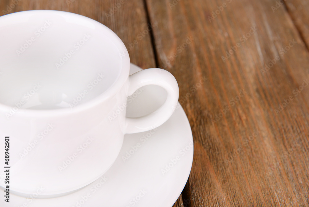 Empty cup with tea spoon on wooden background Empty cup with tea spoon on wooden background