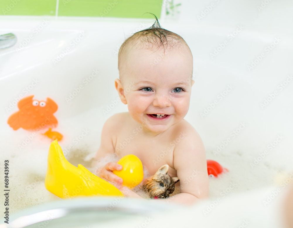 smiling baby taking bath and playing with toys smiling baby taking bath and playing with toys