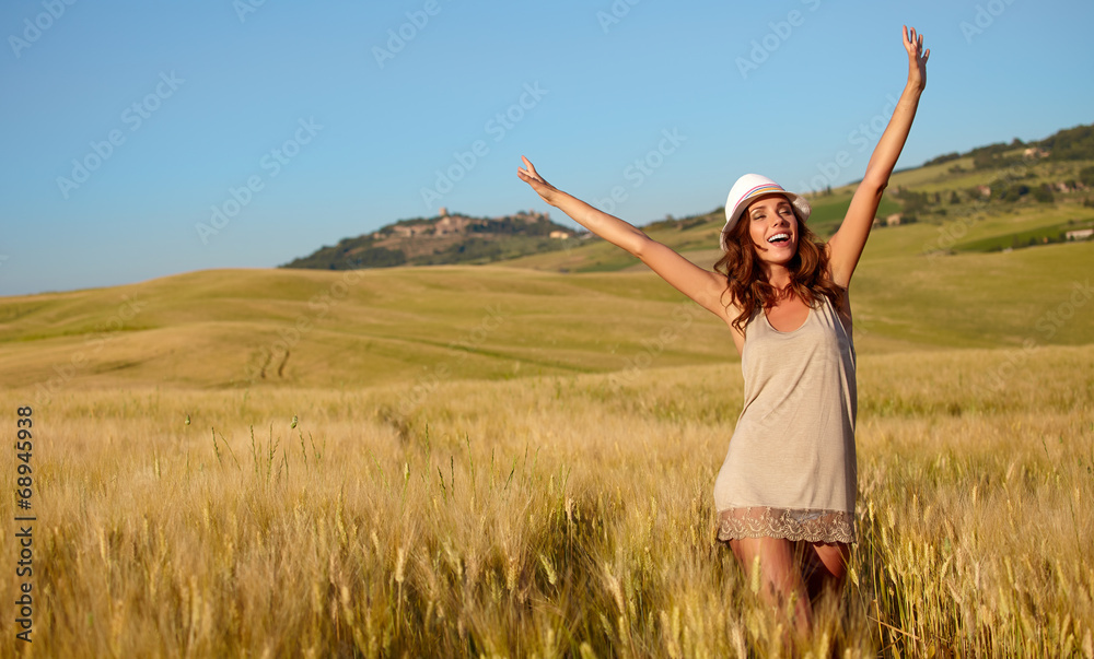 Portrait of a woman on golden cereal field in summer Portrait of a woman on golden cereal field in summer