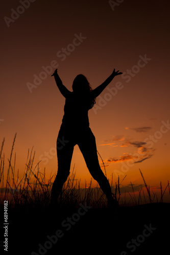 Happy woman jumping. Silhouette in the sunset sky