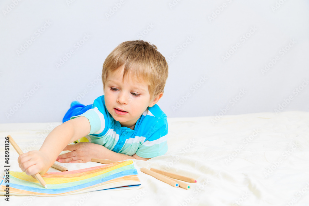 little boy drawing at home