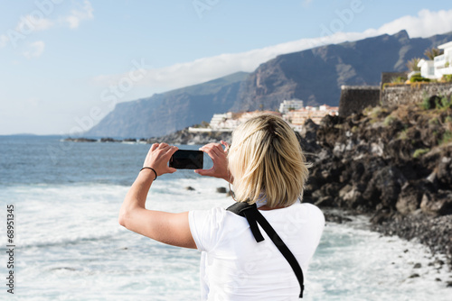 Woman taking picture on mobile phone at Tenerife