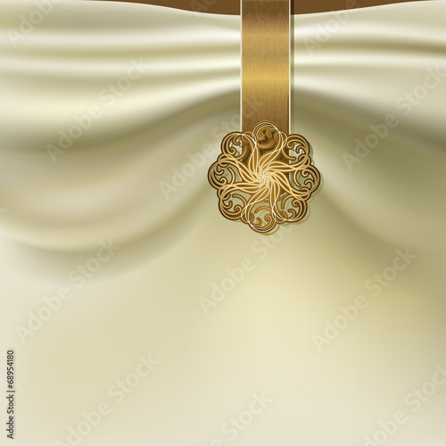 Unusual background with folds of fabric and gold brooch