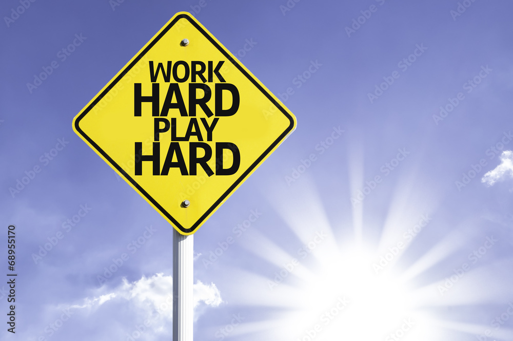 Work Hard Play Hard road sign with sun background Work Hard Play Hard road sign with sun background