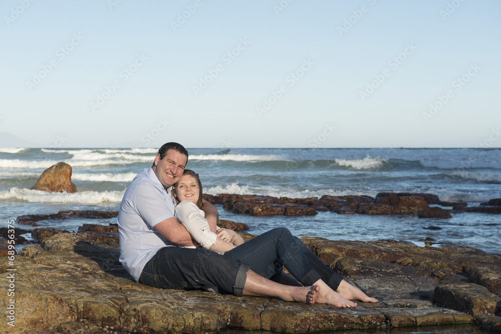 Couple sitting on a rock