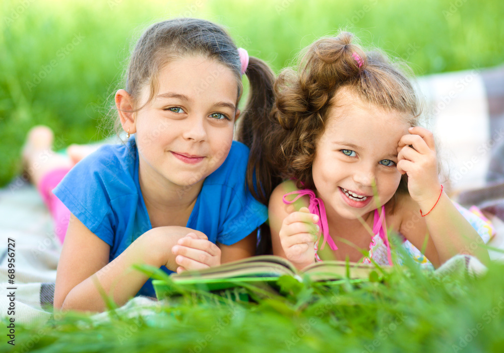 Two little girls are reading book Two little girls are reading book