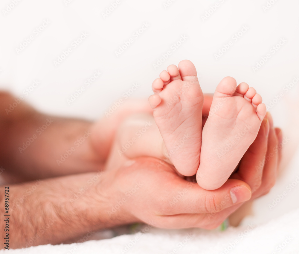 Father holding his newborn baby's feet Father holding his newborn baby's feet