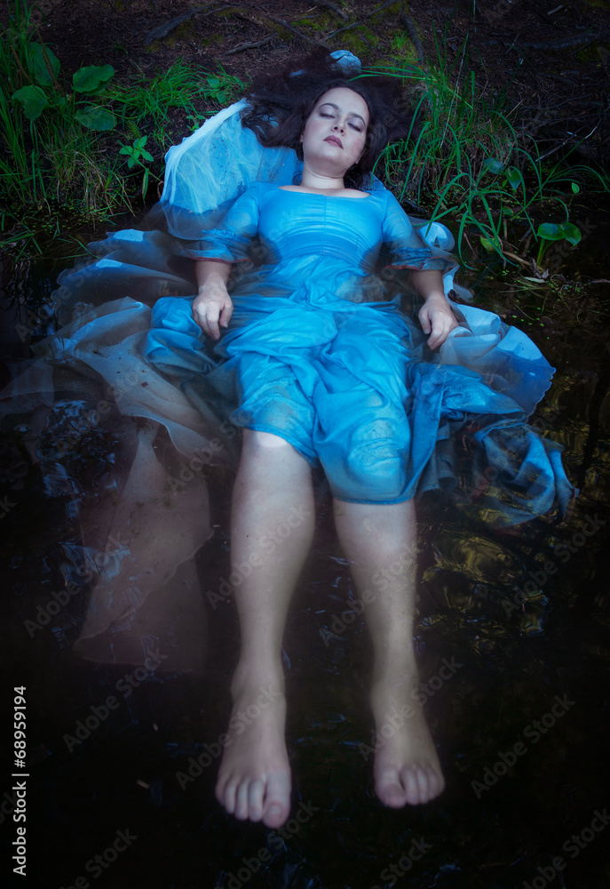 Young beautiful drowned woman lying in the water Young beautiful drowned woman lying in the water