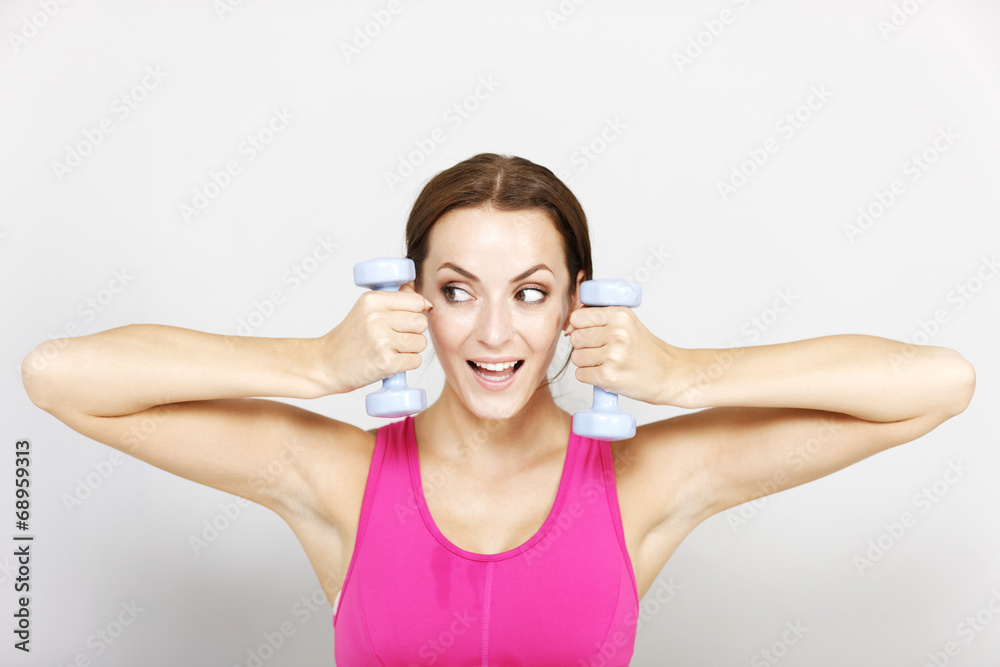 Woman using gym weights Woman using gym weights