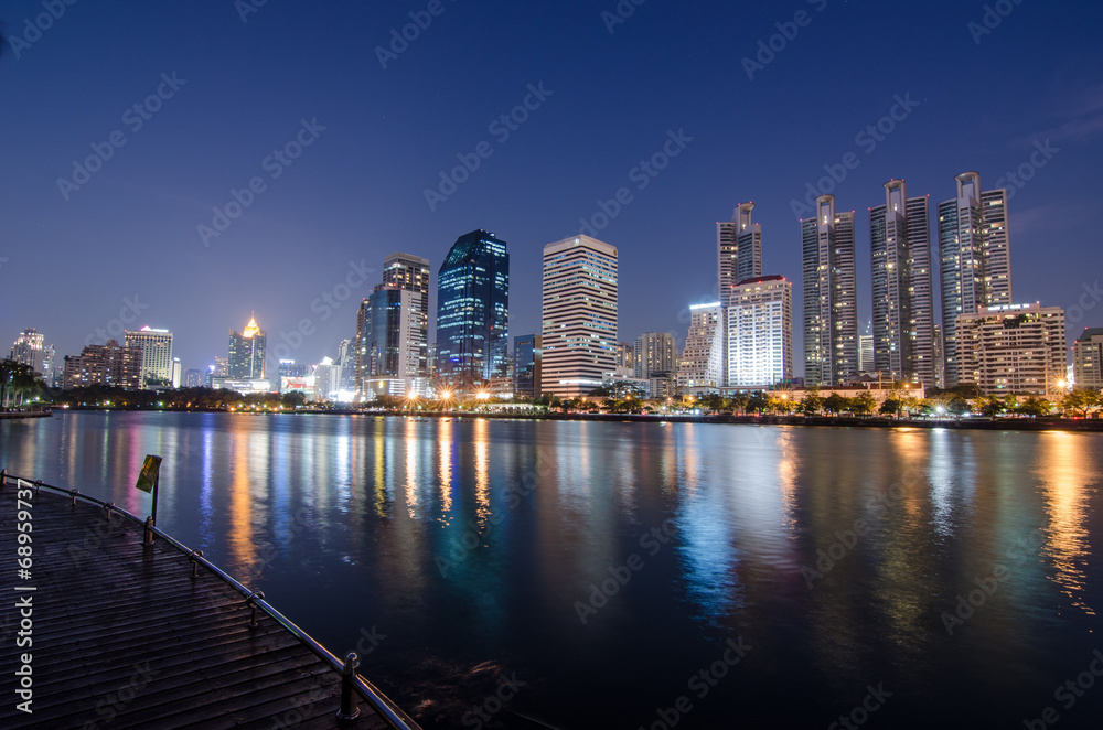 Fototapeta premium Bangkok city at night with reflection of skyline