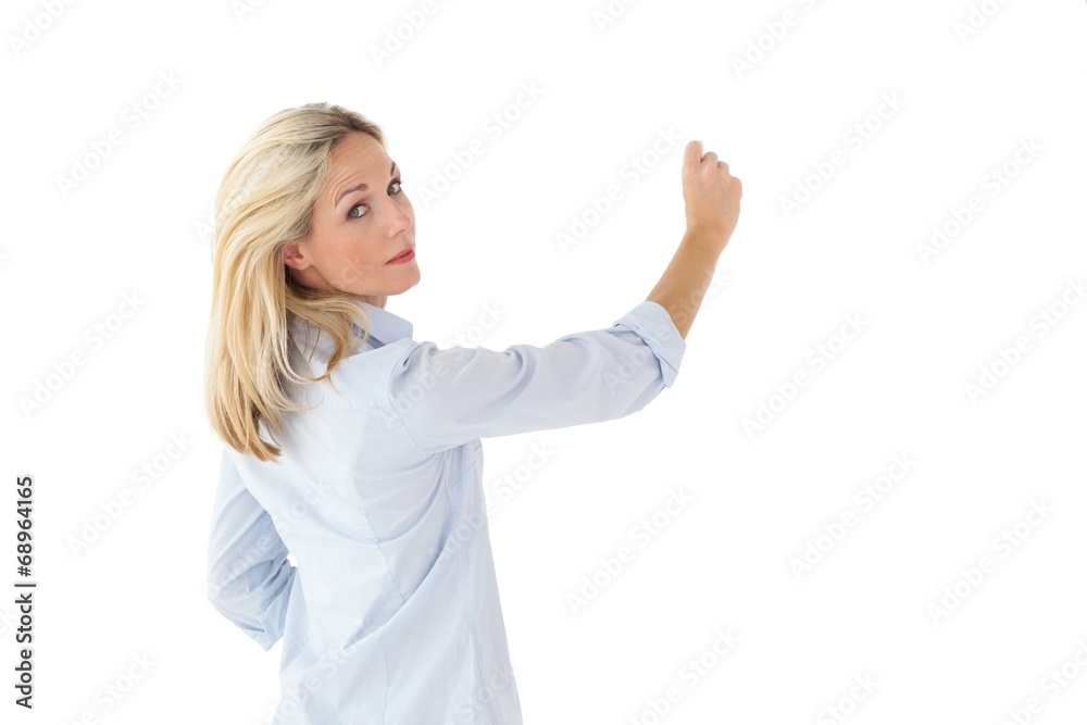 Smiling blonde woman writing and looking at camera Smiling blonde woman writing and looking at camera
