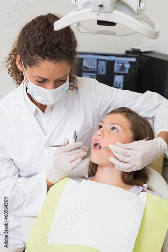 Pediatric dentist examining a patients teeth