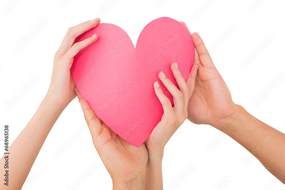 Fototapeta premium Couple holding a paper heart