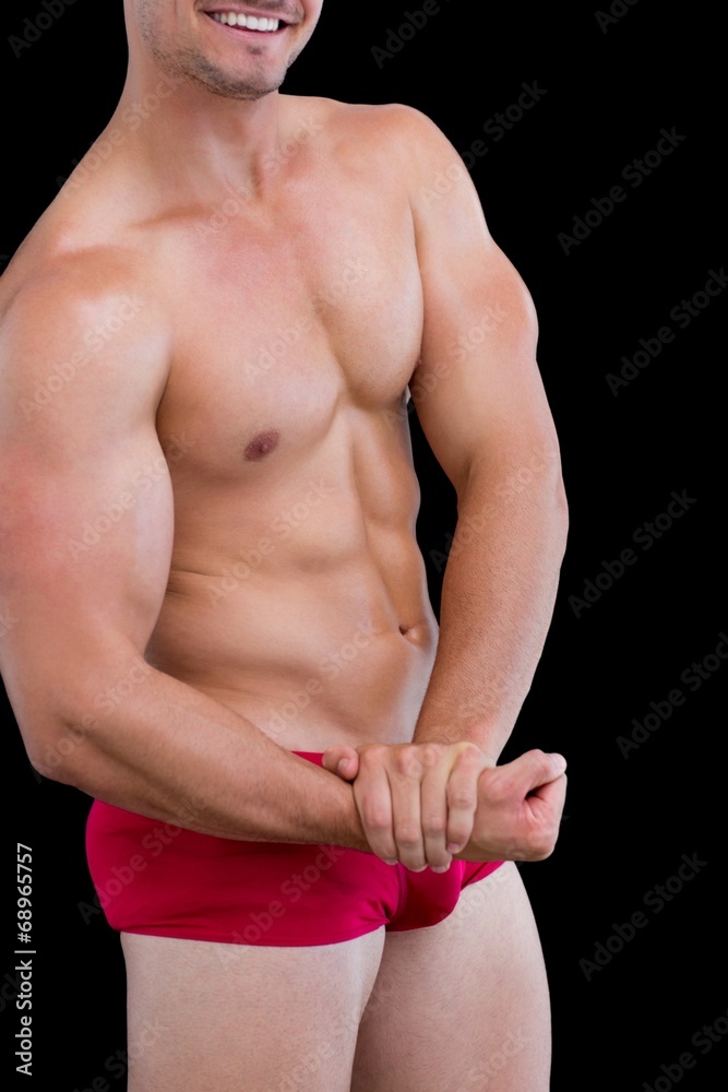 Close-up mid section of a shirtless muscular man Close-up mid section of a shirtless muscular man