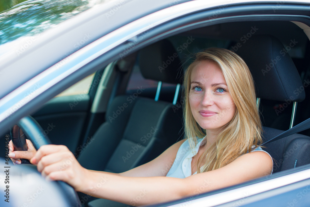 Beautiful young woman driving a car.