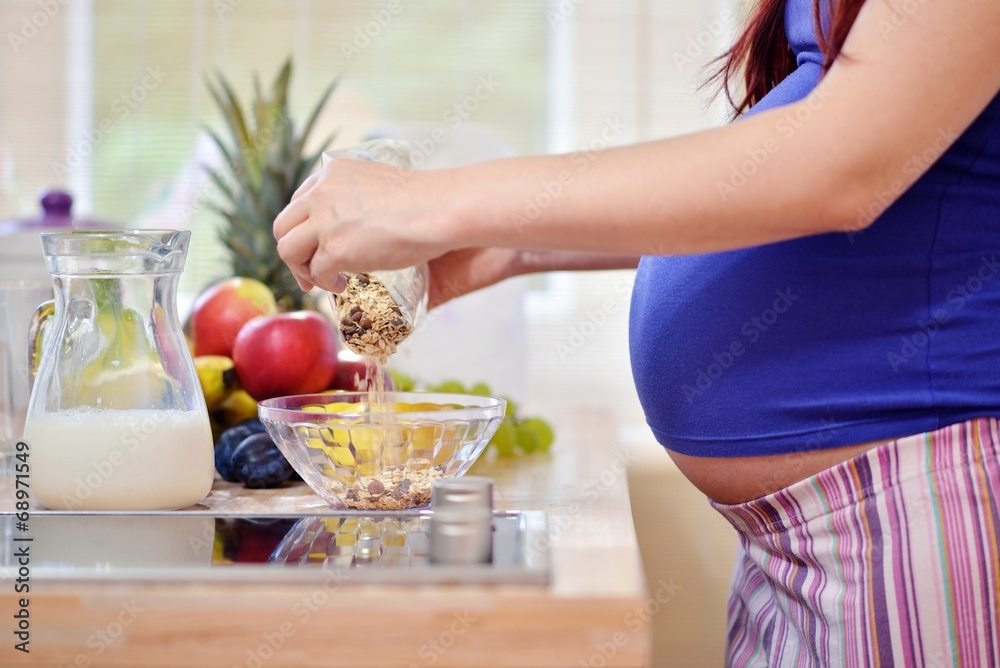pregnant woman prepering meal pregnant woman prepering meal