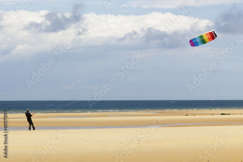 Man playing with a kite at the beach