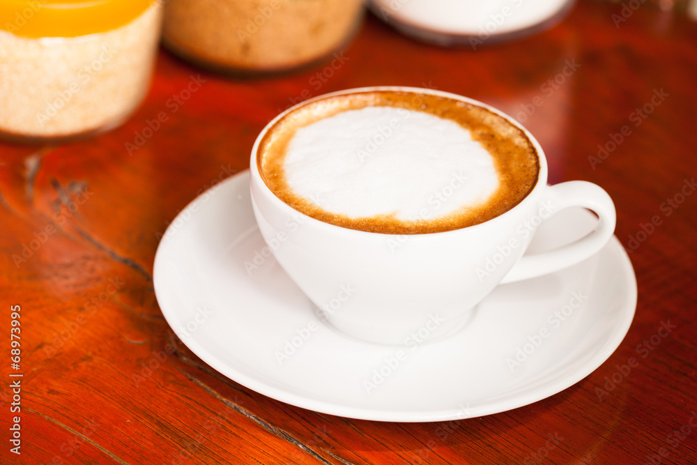 Cup of cappuccino or latte coffee on wood. Cup of cappuccino or latte coffee on wood.