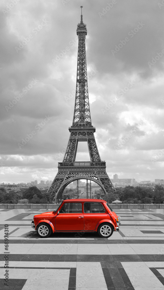 Eiffel tower with car. Black and white photo with red element. - obrazy, fototapety, plakaty 