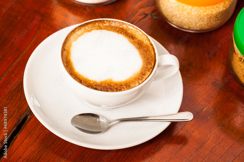Cup of cappuccino or latte coffee on wood. Cup of cappuccino or latte coffee on wood.