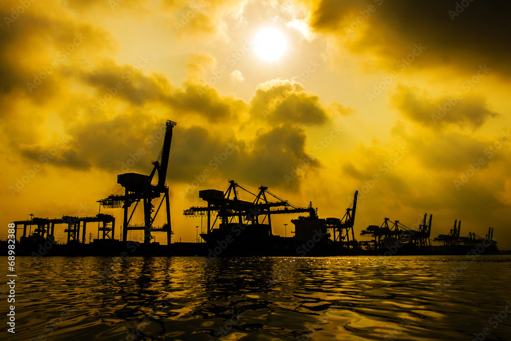Silhouette of Container Cargo freight ship with working crane br Silhouette of Container Cargo freight ship with working crane br