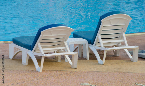 Beach chairs near swimming pool