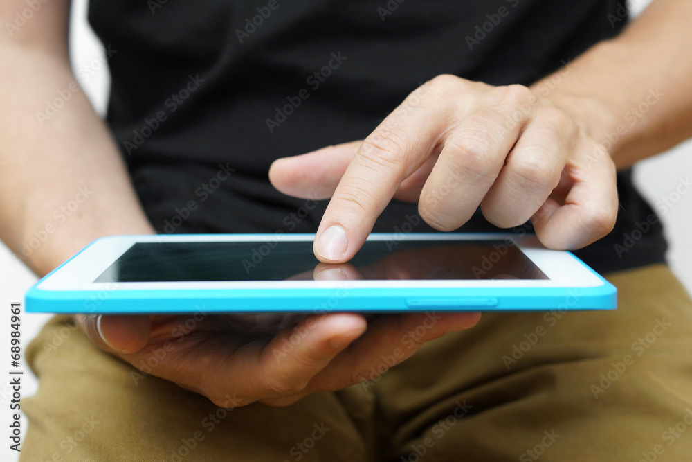 A Man working on a tablet pc with he's hand A Man working on a tablet pc with he's hand