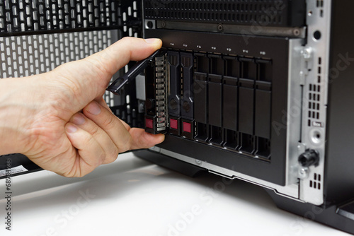 Photography inserting disk into data server