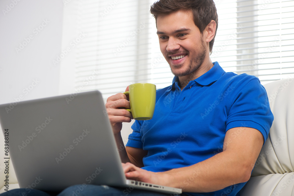 Young man happy on sofa with laptop. Young man happy on sofa with laptop.