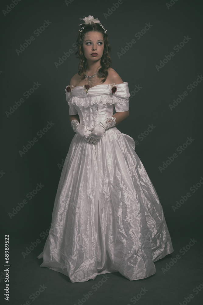Victorian fashion woman wearing white dress. Studio shot against Victorian fashion woman wearing white dress. Studio shot against