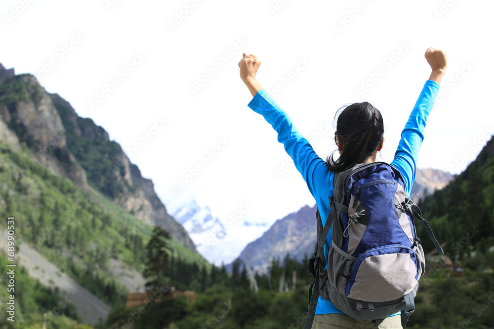 cheering young woman hiker open arms to the snow mountain cheering young woman hiker open arms to the snow mountain