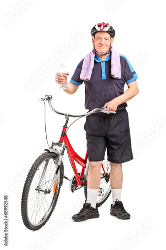 Mature biker holding a water bottle