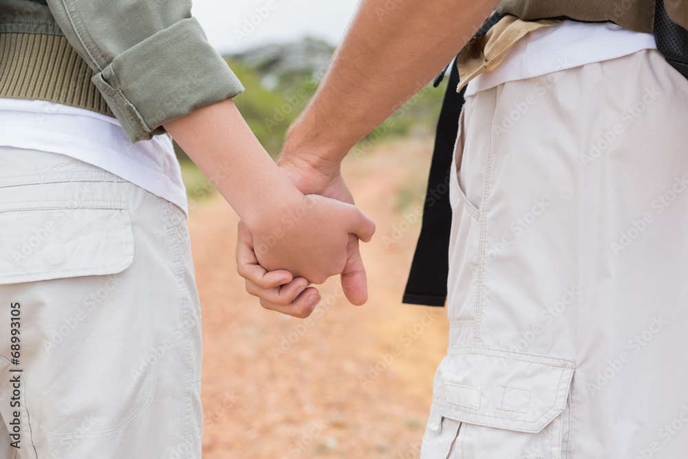 Close up of hiking couple holding hands