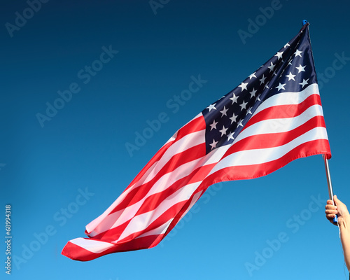 Hand holding american flag