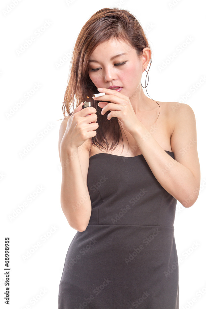 Chinese woman in black dress lighting a cigarette Chinese woman in black dress lighting a cigarette