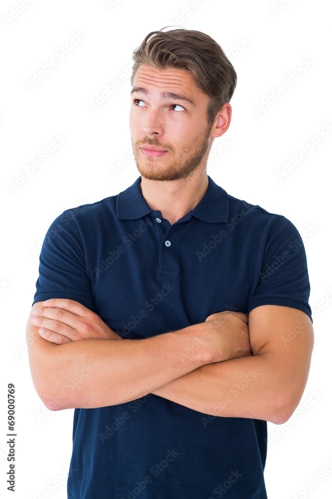 Handsome young man thinking with arms crossed Handsome young man thinking with arms crossed