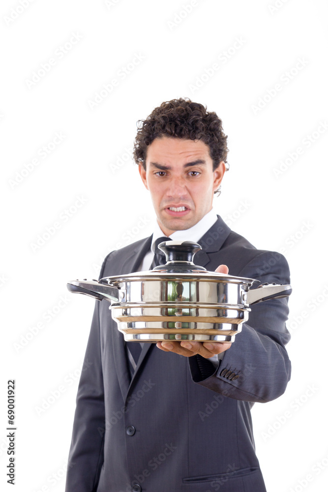 man looking at pot for cooking with expression
