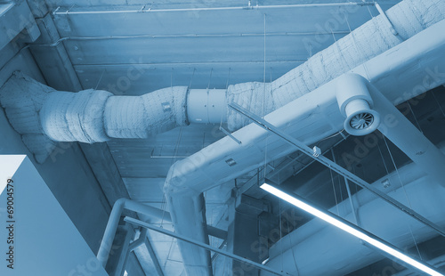 Industrial steel ventilation pipes inside of building.