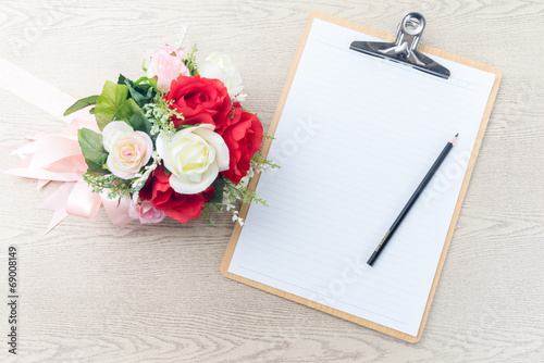 Wooden Clipboard attach planning paper with pencil beside rose b