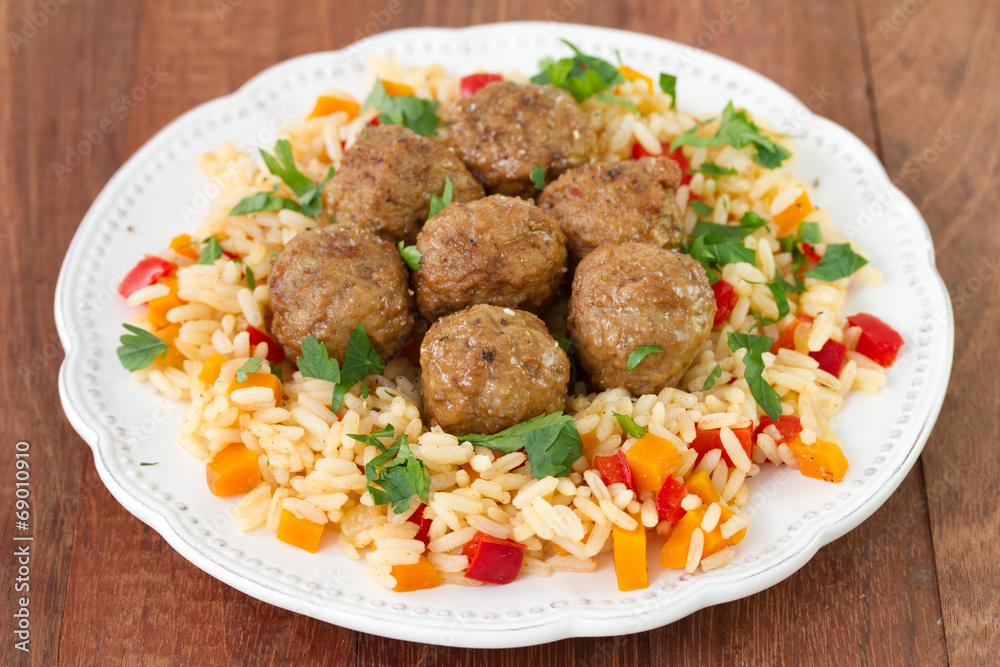 Fototapeta premium meatballs with rice with vegetables on white plate