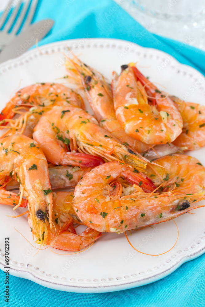 shrimps in white plate and glass of wine